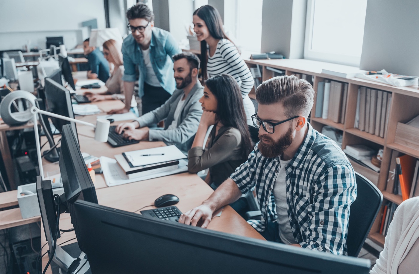 Team collaborating at their desks